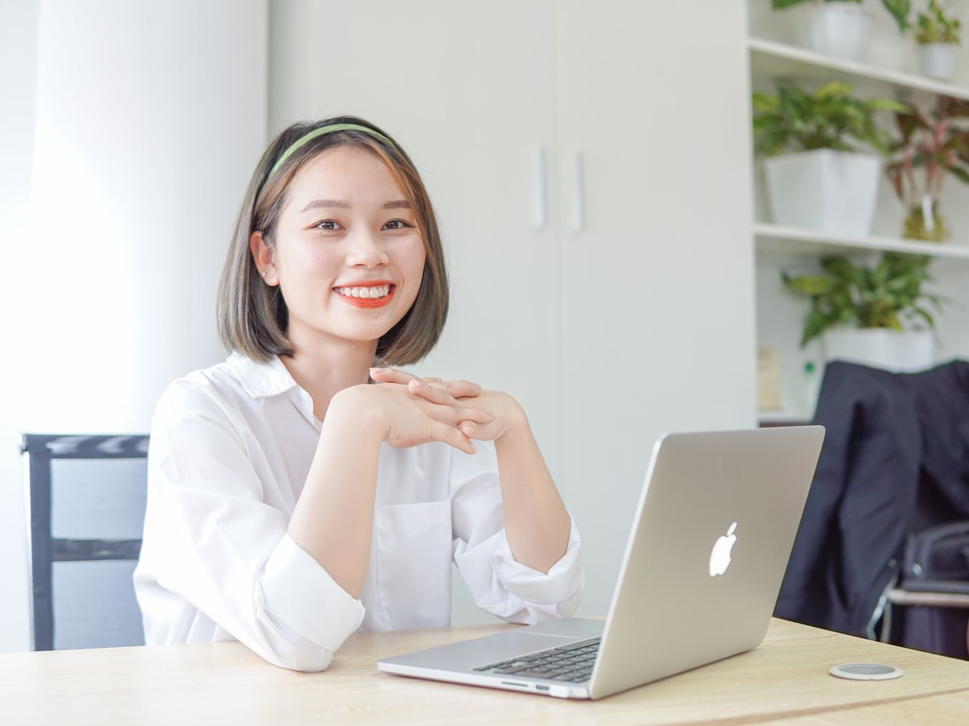 A professional at her laptop in a bright office