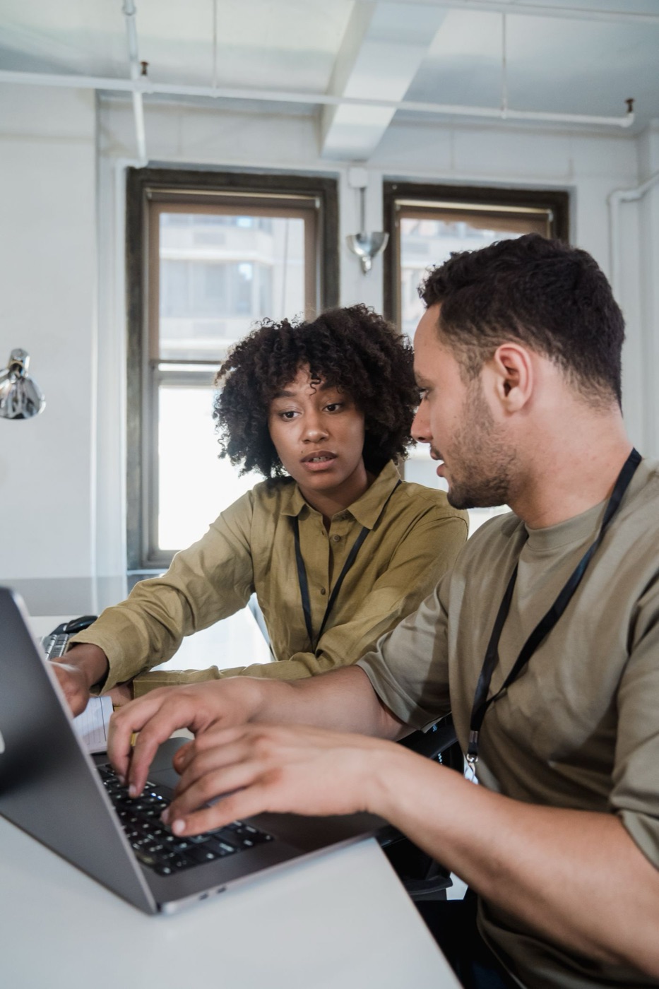 Two engineers reviewing a site together at a laptop