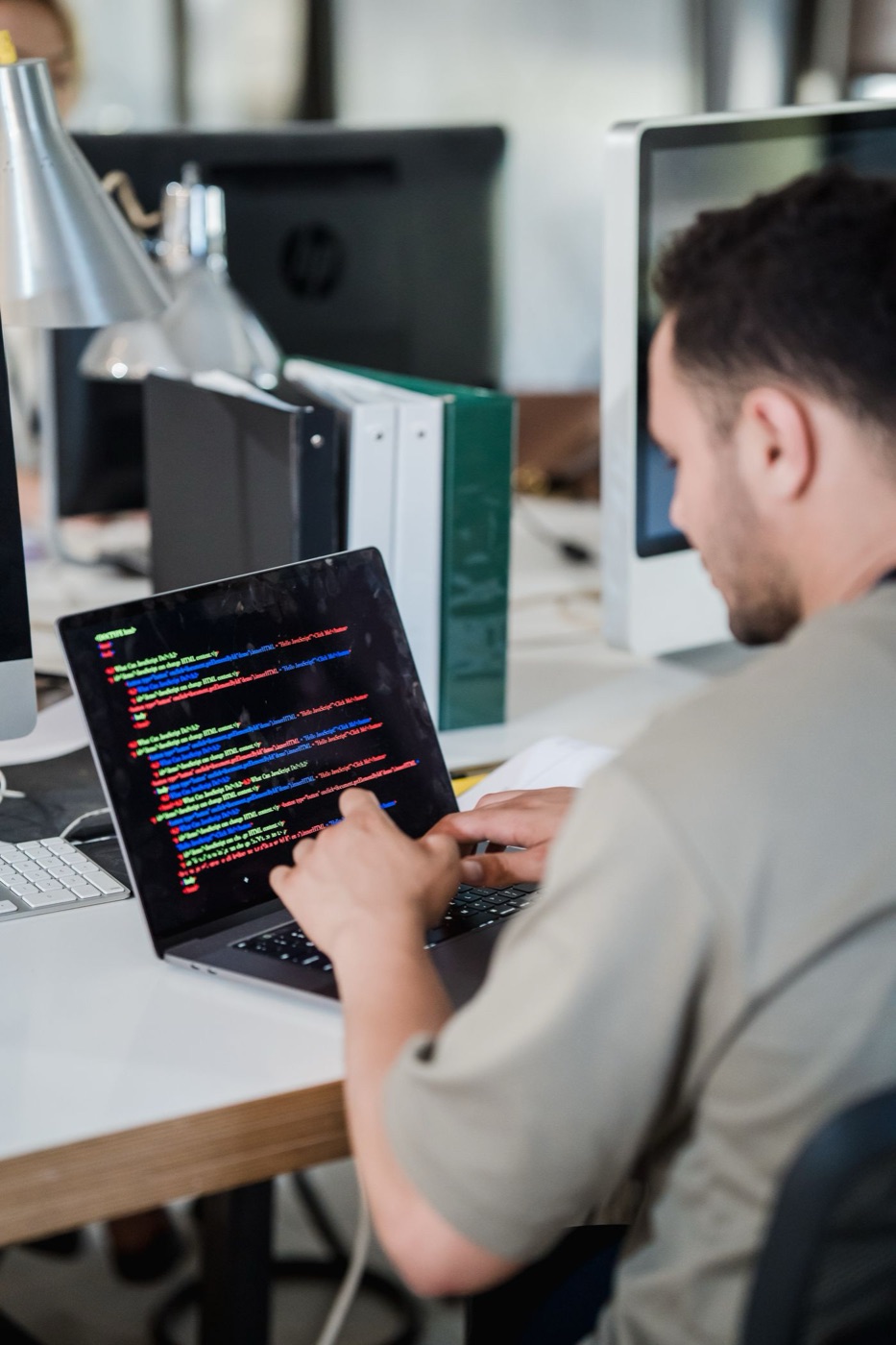 A developer checking code on a laptop