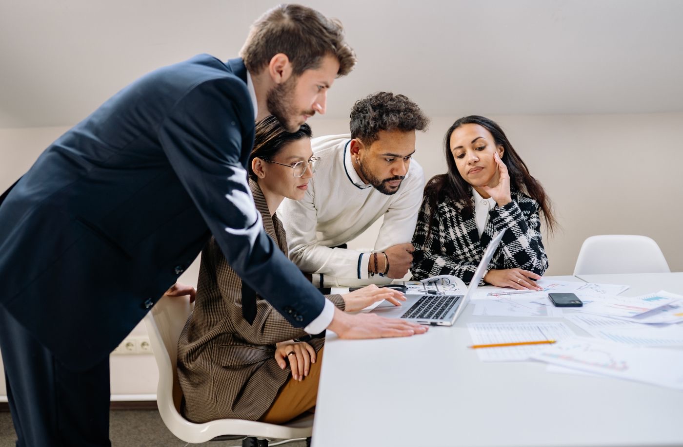 A team reviewing a website design together on a laptop